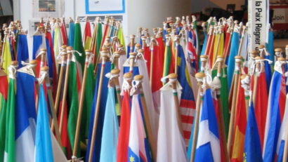 National flags (furled) and Peace Pole (World Peace Prayer Society) at the 2009 Parliament of the World Religions in Melbourne.